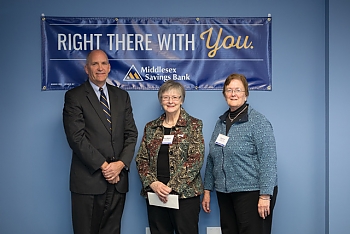 Library Trustees posing with Middlesex Savings Bank official