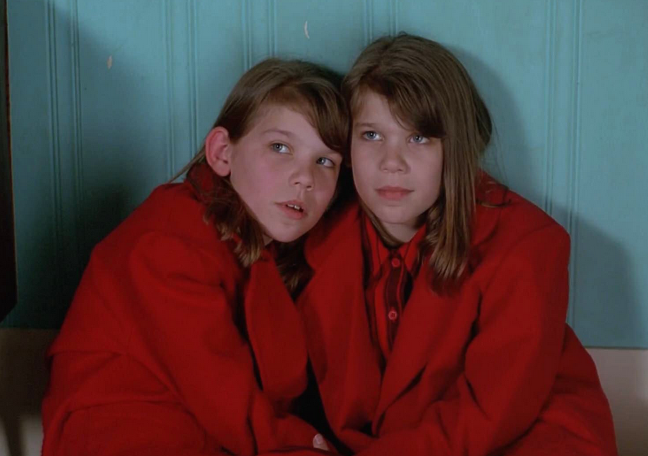 Sweet looking twin girls in red coats. Cute, but not to be trusted.